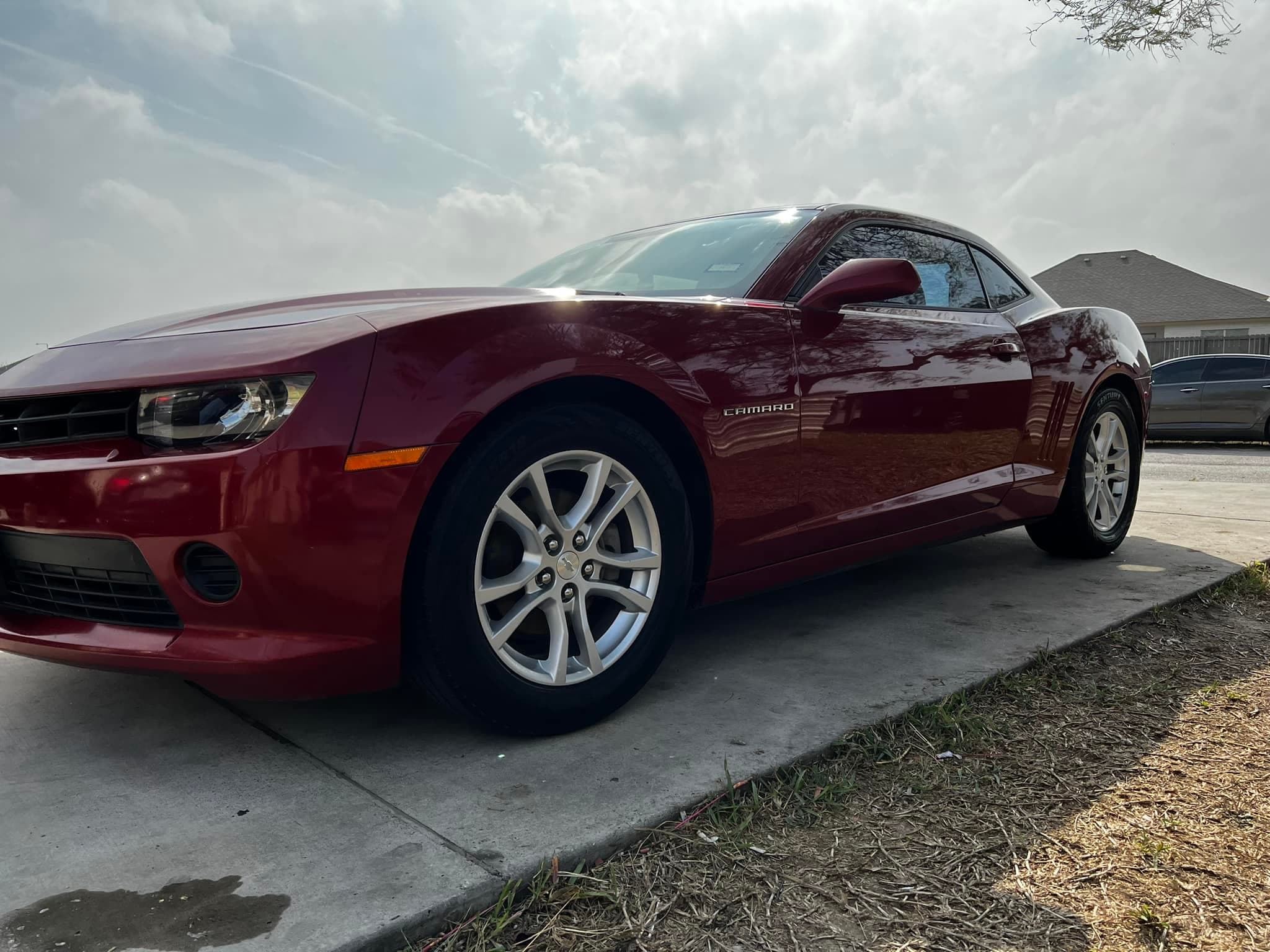 Candy-red Chevrolet Camaro detailed to a mirror gloss, low front three-quarter view
