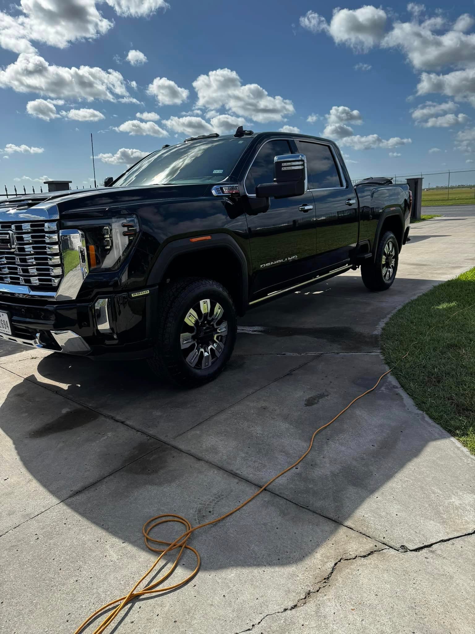 Black GMC Denali HD, grille and paint gleaming after service