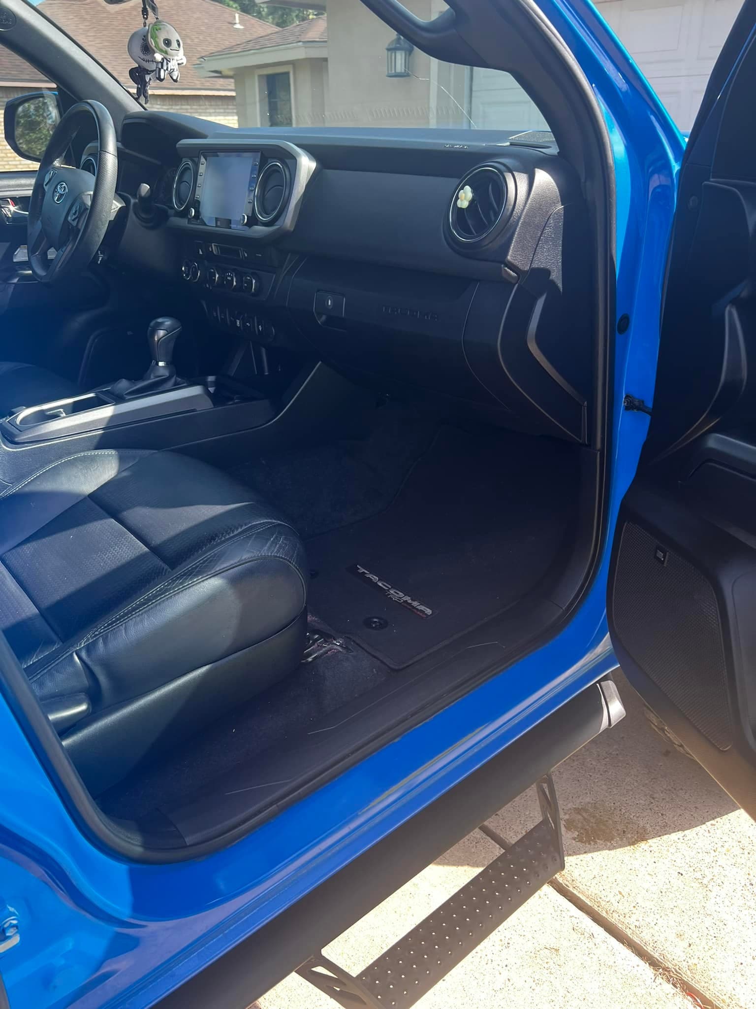 Toyota Tacoma cabin after a full interior detail: leather seats, dash, vents, and mats spotless
